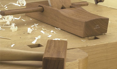 Work space with wood flakes and wooden mallet