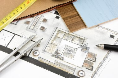 Building plan sketch with tape measure and other tools